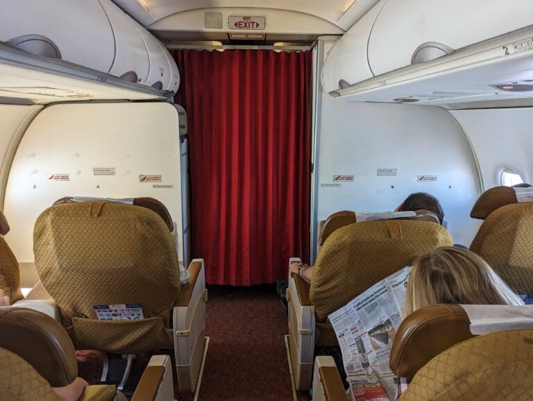 a group of people sitting in chairs on an airplane