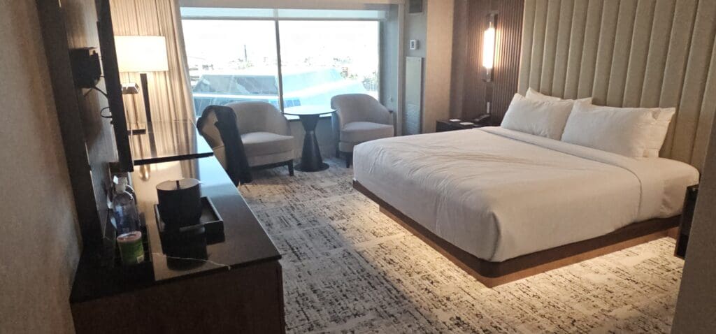 a room with a bed and chairs