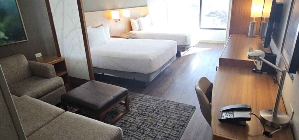 a room with two beds and a table