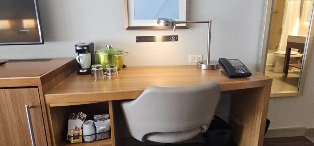 a desk with a chair and a lamp