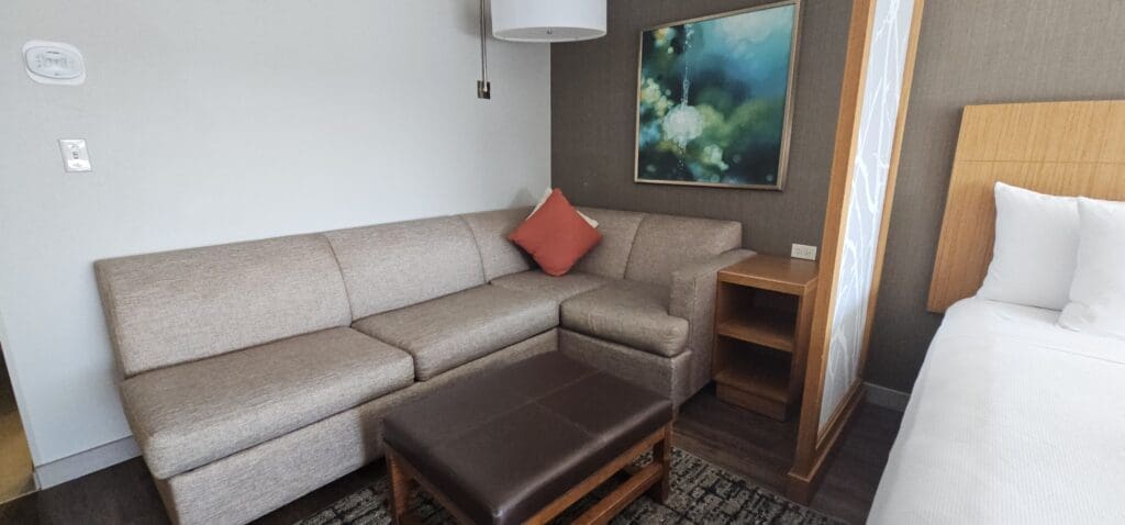 a couch with a stool in a room