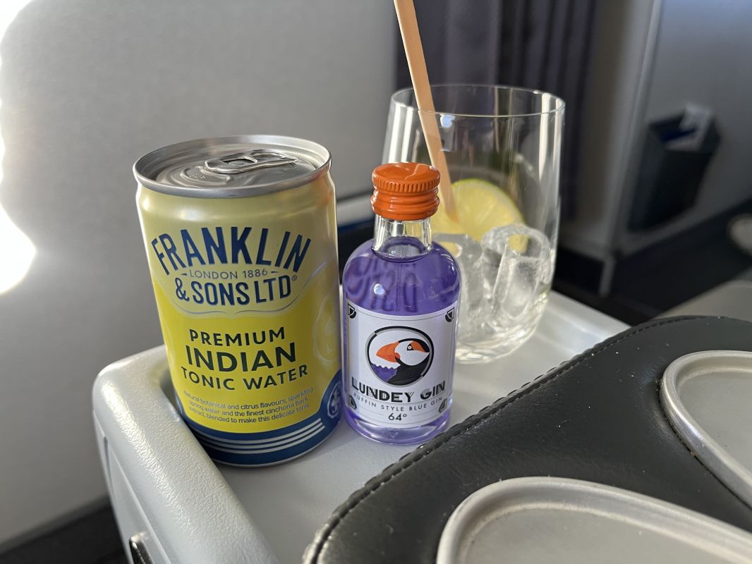 a drink can and a glass on a table