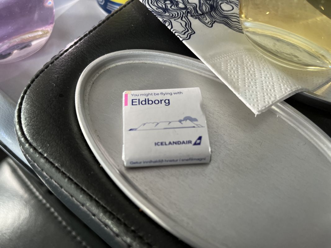 a small white package on a silver tray