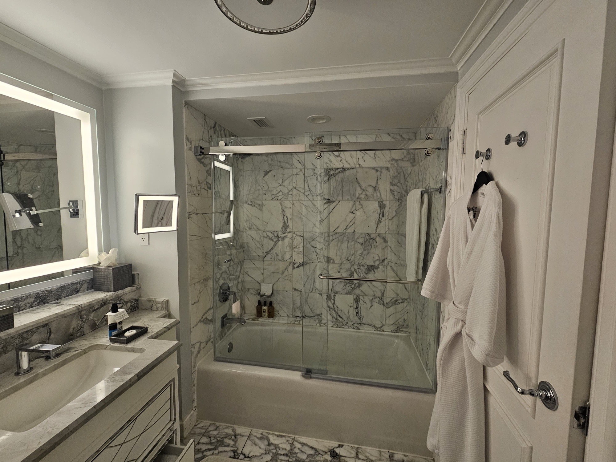 a bathroom with marble tile floor and a bathtub at the Ritz Carlton New Orleans