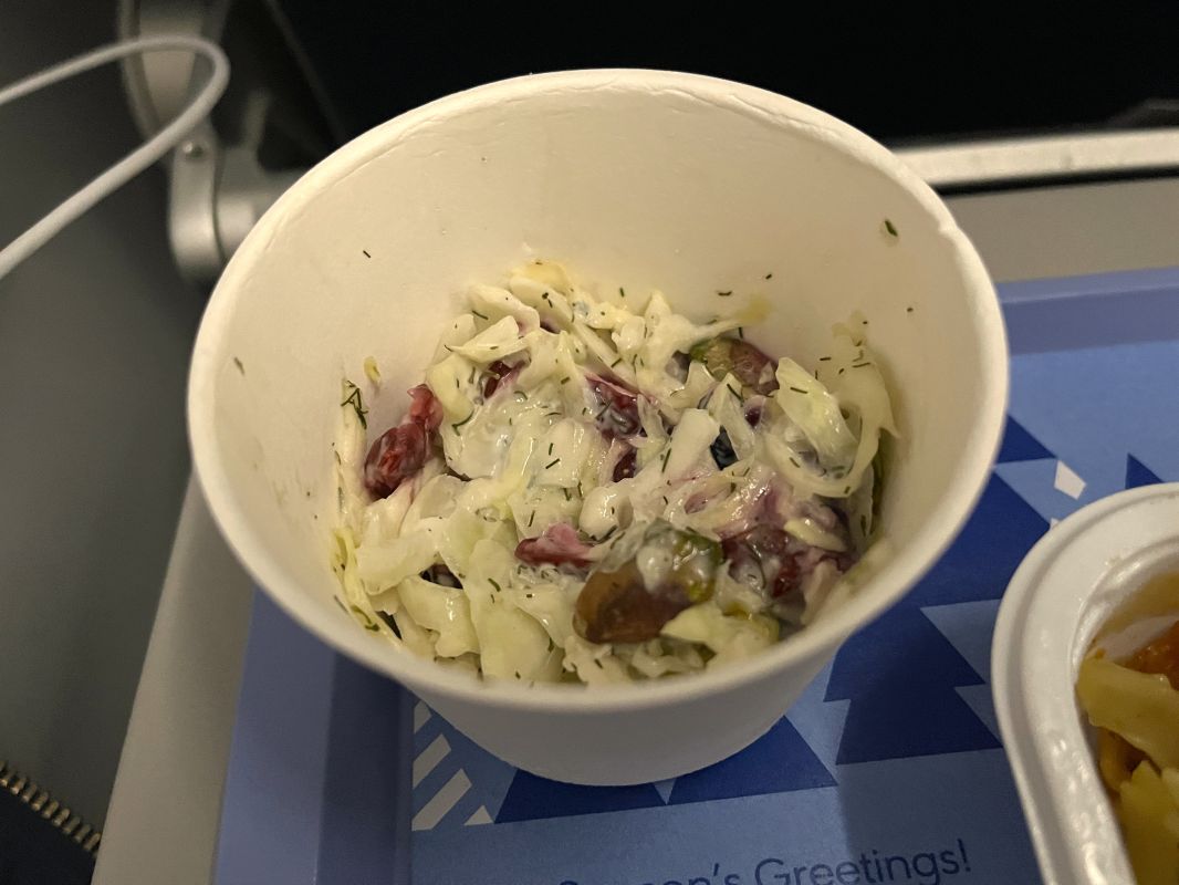 a white cup with food in it