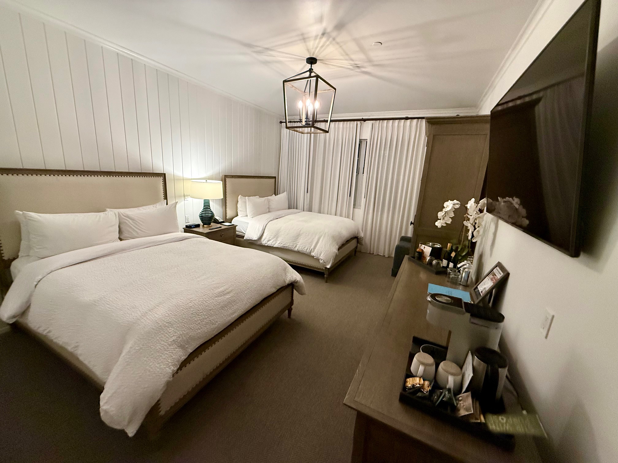 a bedroom with two beds and a tv at the Vespera Resort Pismo Beach