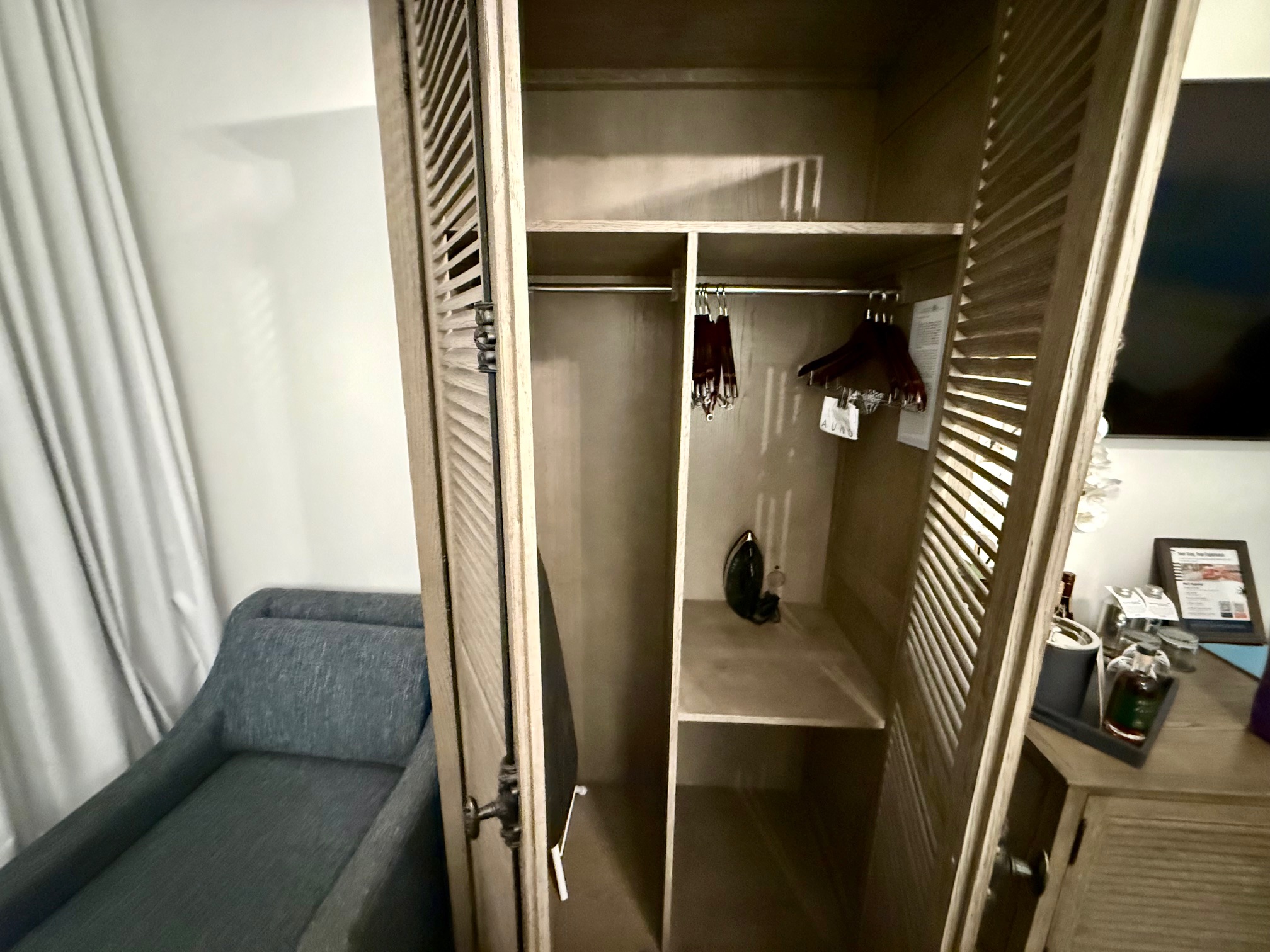 a closet with a shelf and a couch