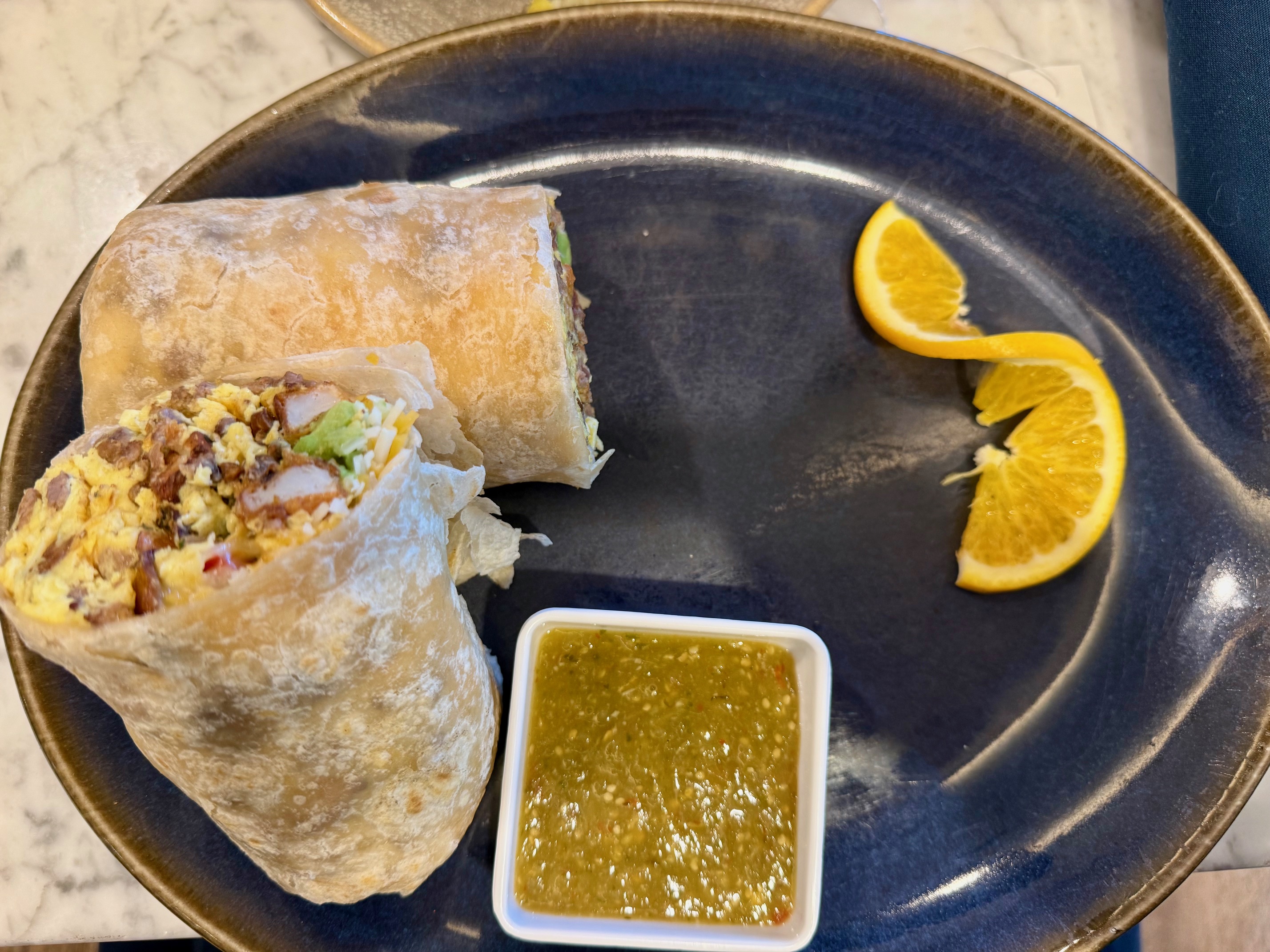 a plate of food with a slice of lemon and a plate of food