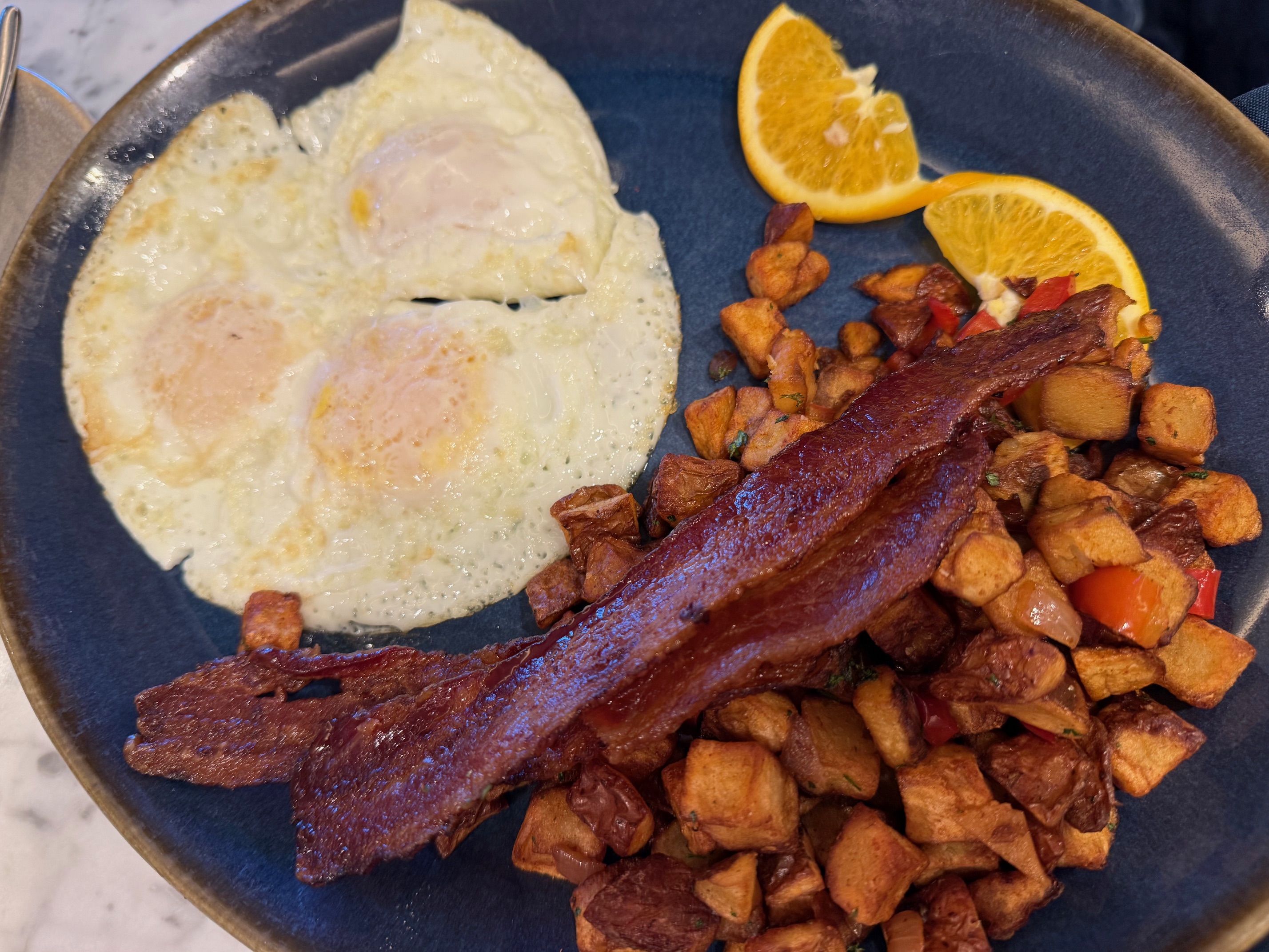 a plate of food with eggs and potatoes