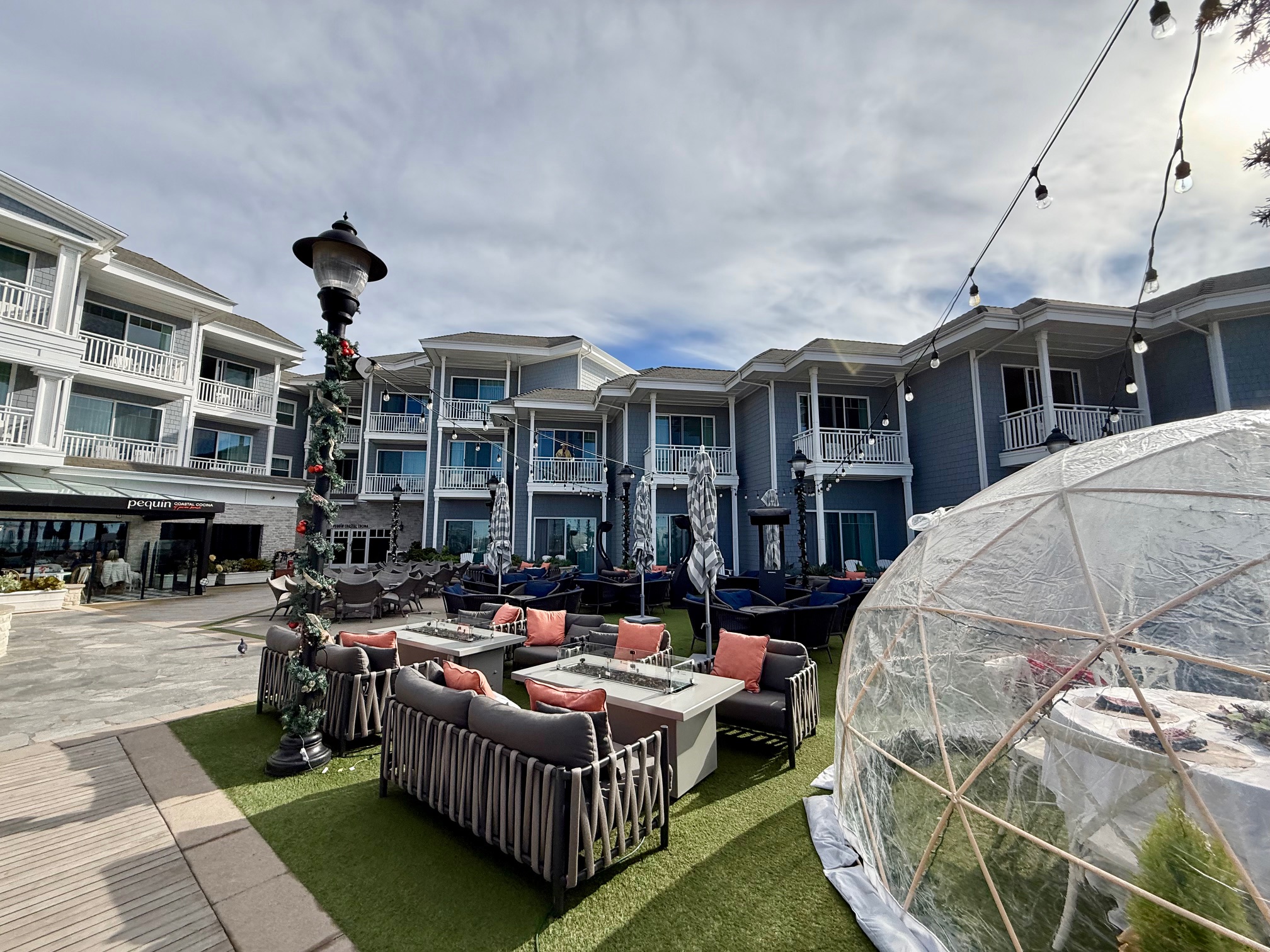 a patio area with furniture and a dome in the background at Vespera Resort Pismo Beach