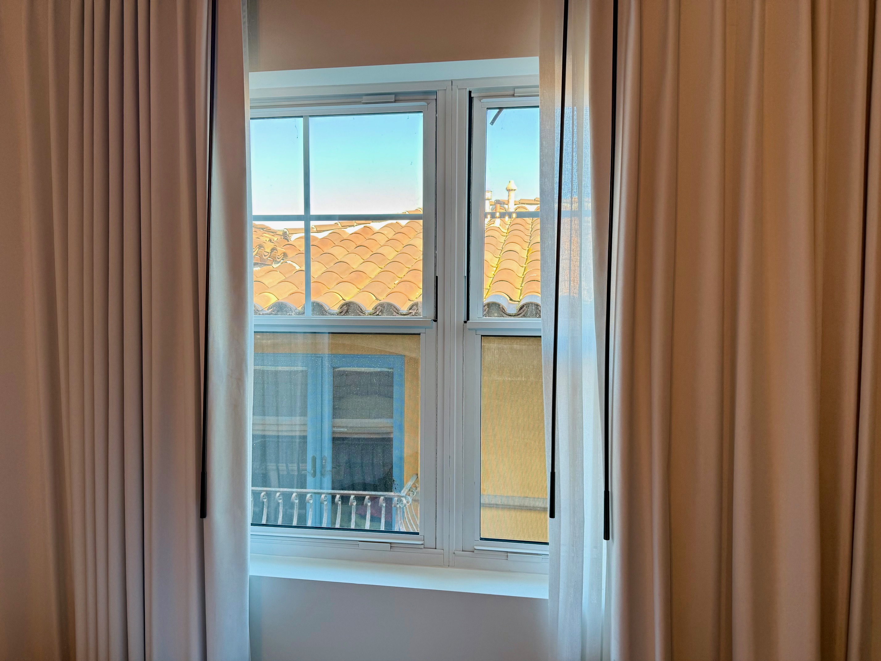 a window with curtains and a roof