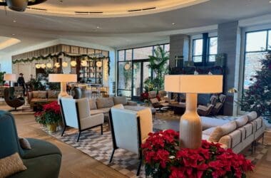 a room with a large living room with a large sofa and chairs