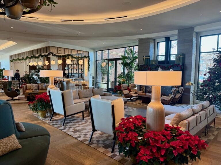 a room with a large living room with a large sofa and chairs