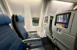 seats on an United 737-900ER with a television screen
