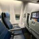 seats on an United 737-900ER with a television screen