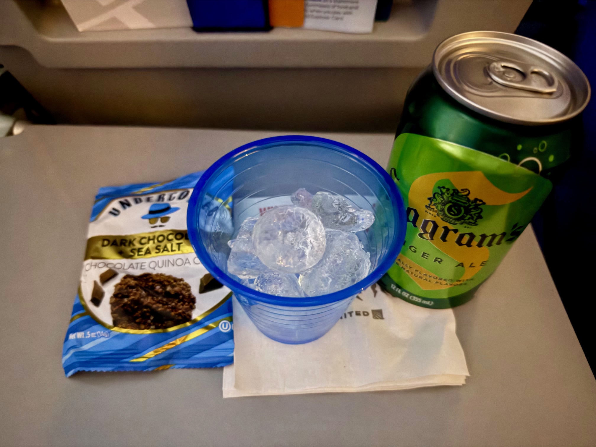 a drink can and a cup of ice