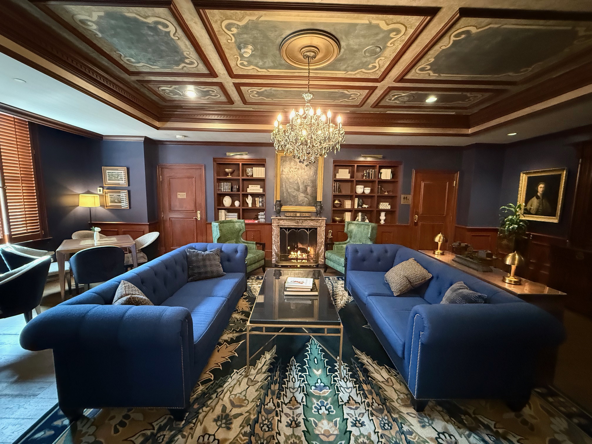 a room with blue couches and a fireplace at the Ritz Carlton New Orleans