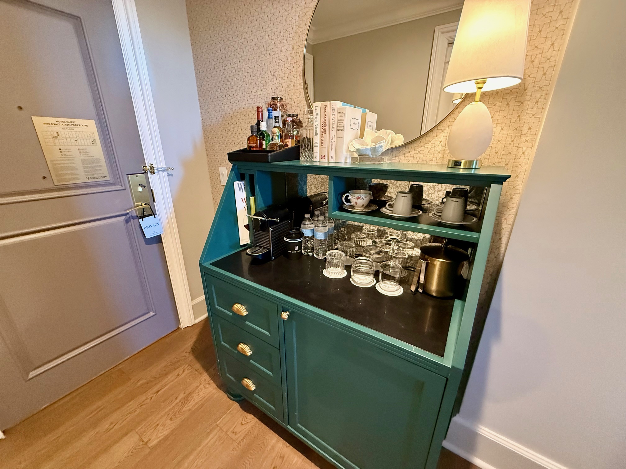 a green dresser with a mirror and a lamp at the Ritz Carlton New Orleans