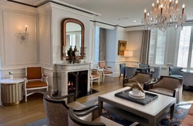 a room with a fireplace and chandeliers at the Ritz Carlton New Orleans Club Level