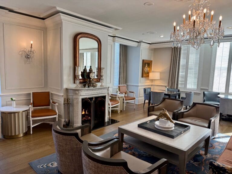 a room with a fireplace and chandeliers at the Ritz Carlton New Orleans Club Level