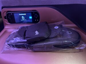 a black hat and cap in a plastic bag on a seat