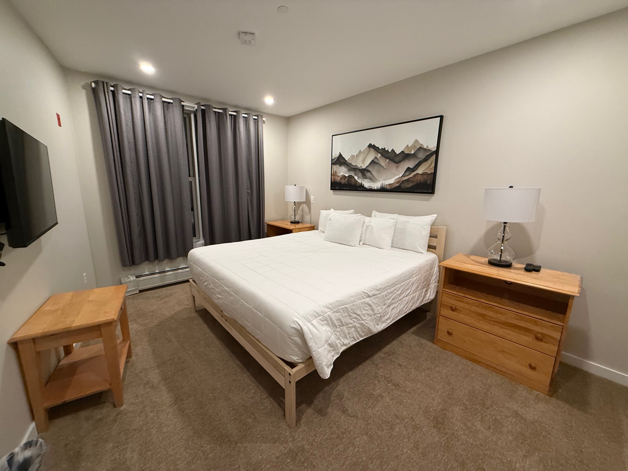 a bedroom with a bed and a dresser