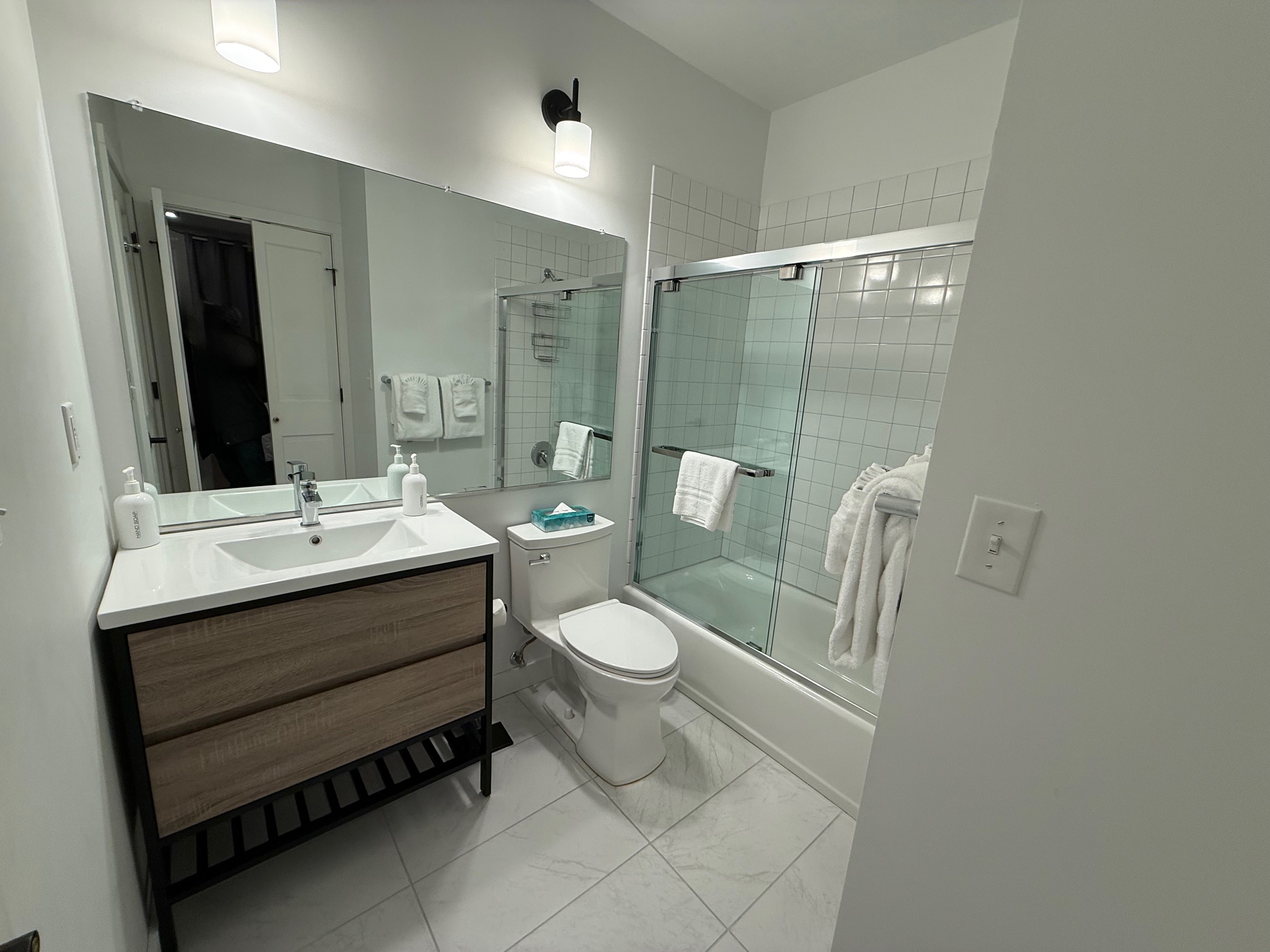 a bathroom with a glass shower and sink