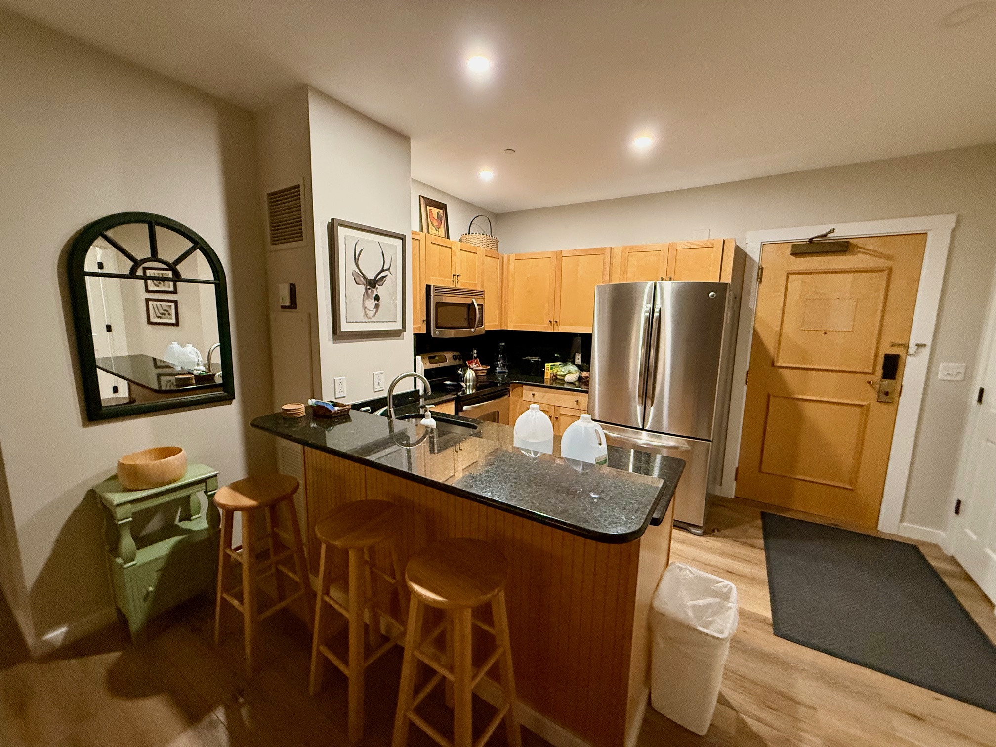 a kitchen with a bar and stools at the Long Trail House Stratton