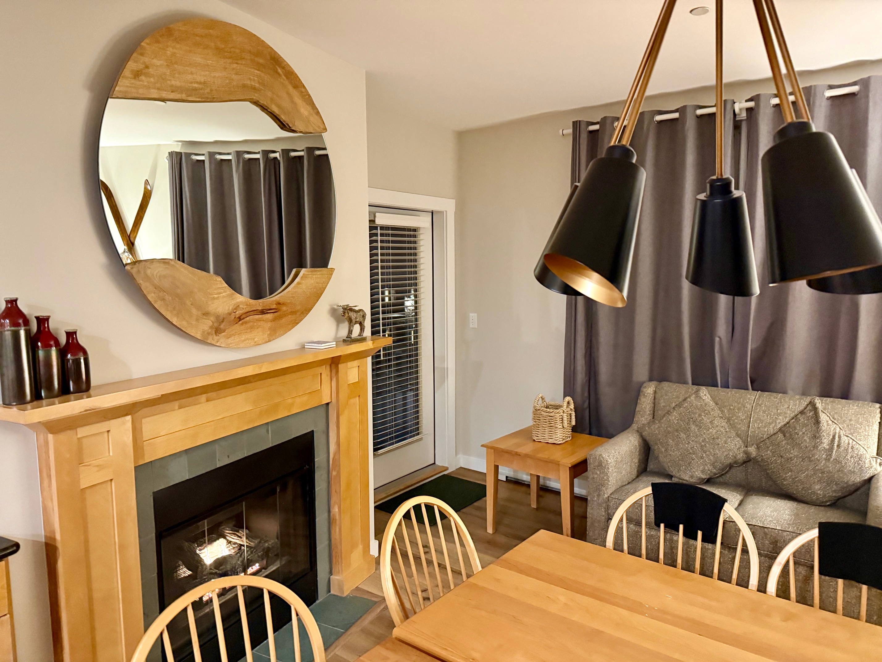a living room with a fireplace and dining table