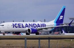 a white and blue airplane on a runway