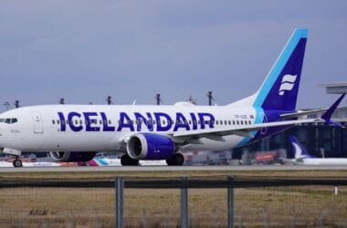 a white and blue airplane on a runway
