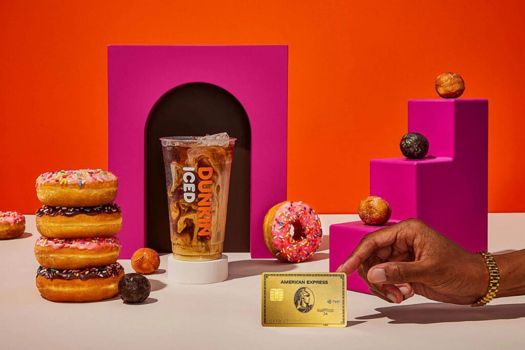 Dunkin' products including an iced coffee and donuts with an American Express Gold Card at the front of the image