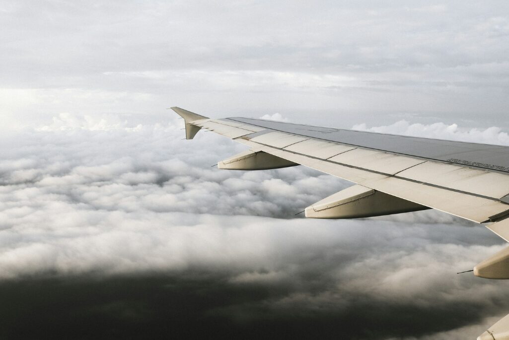 A view of an airplane wing above the clouds