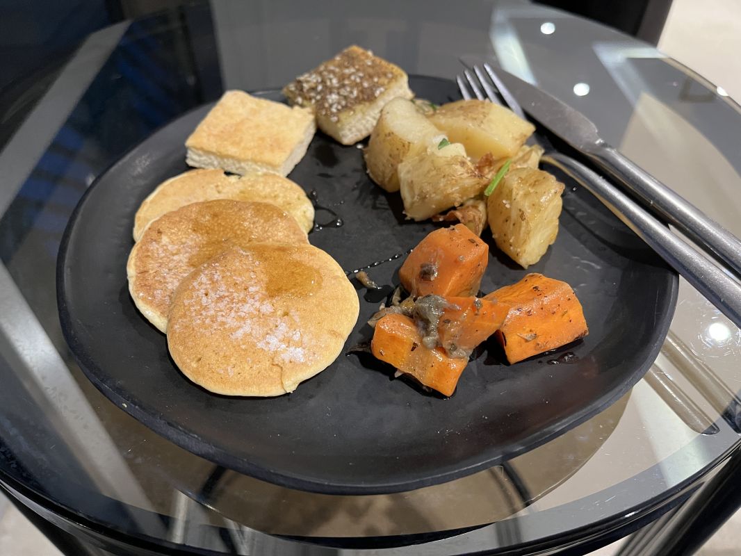 a plate of food on a glass table
