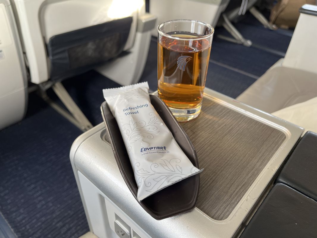 a glass of liquid and a package on a table