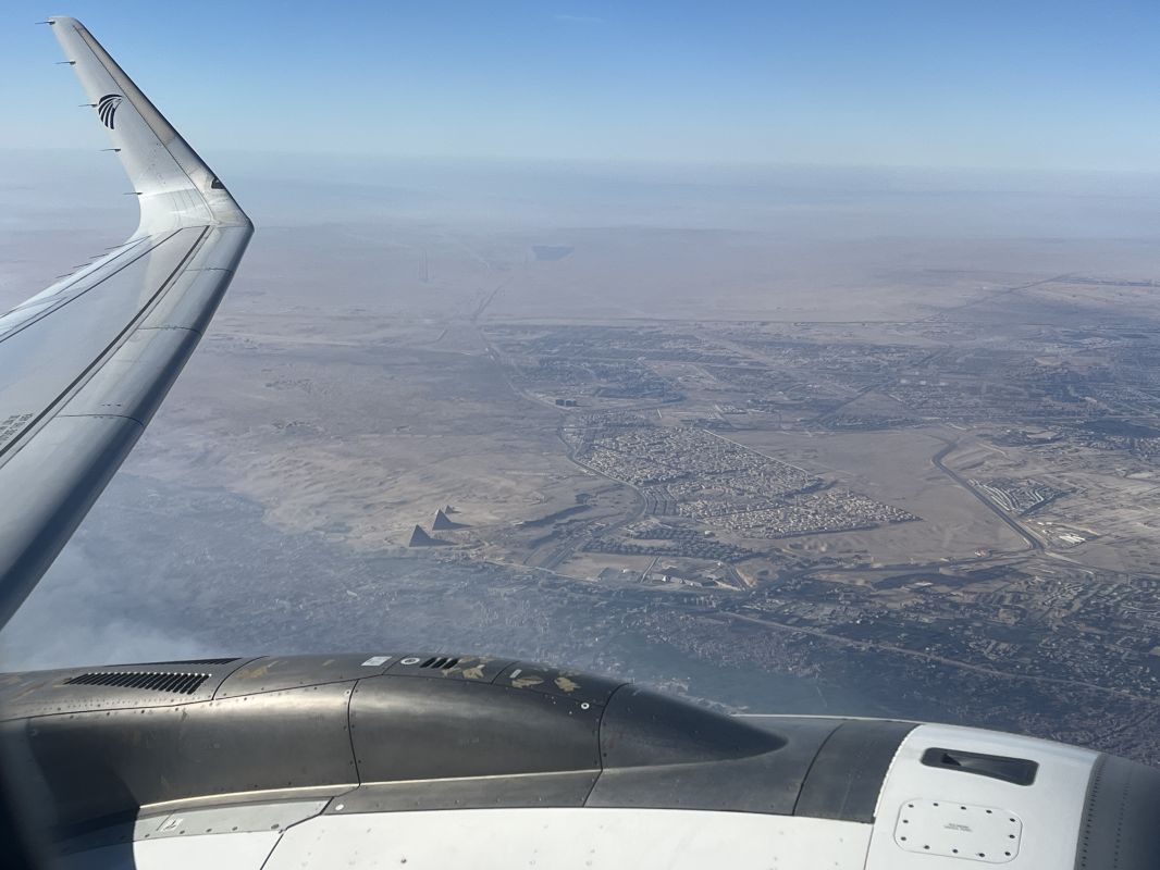 an airplane wing and a city