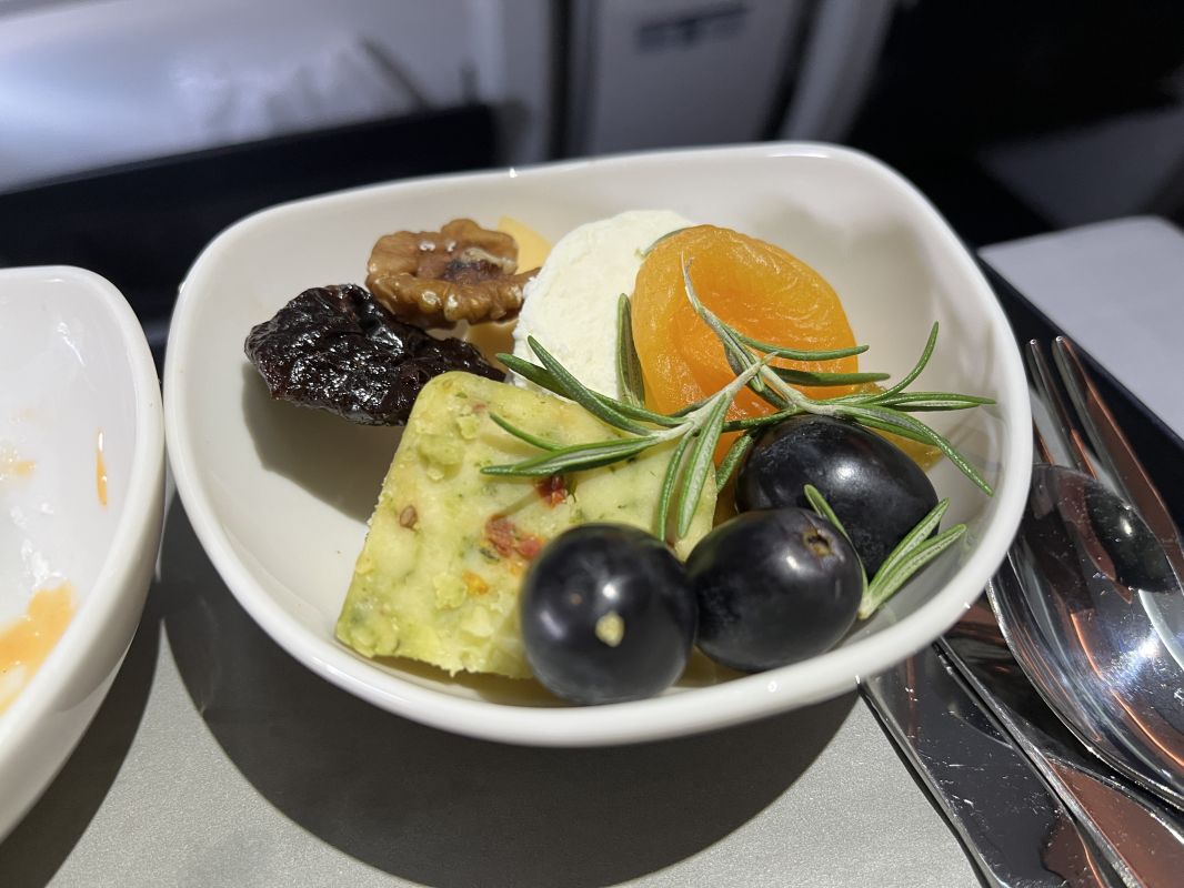 a bowl of fruit and cheese