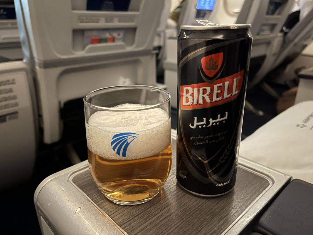 a can and a glass of beer on a table