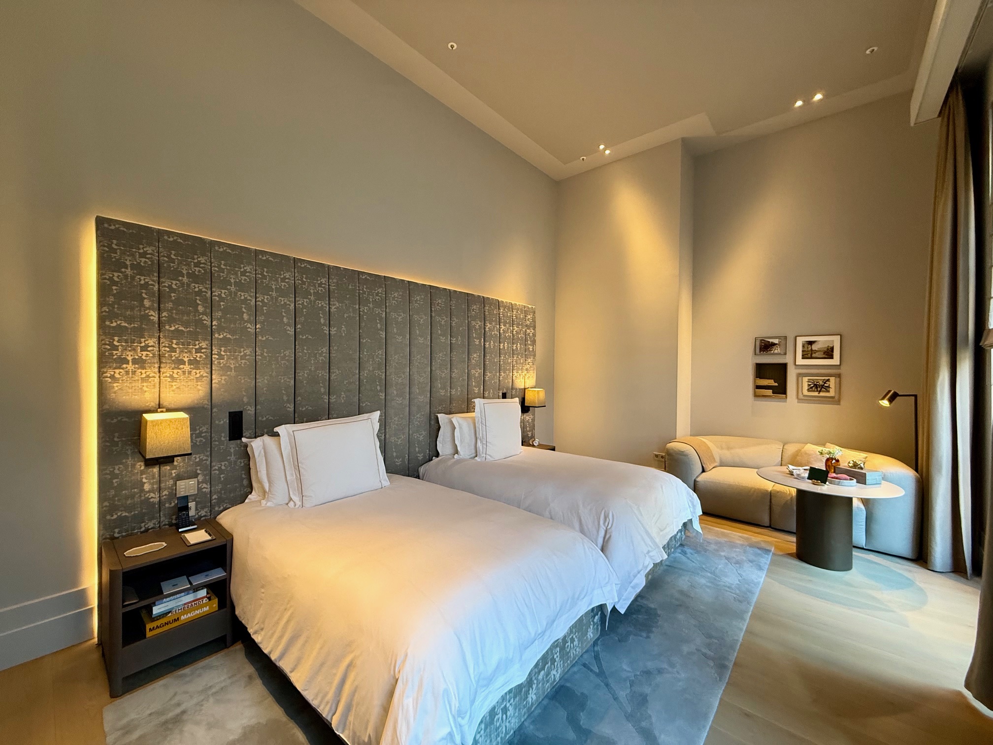 a room with two beds and a couch at the Rosewood Amsterdam