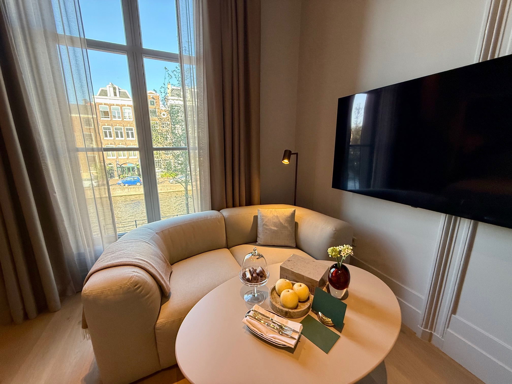 a living room with a round table and a television