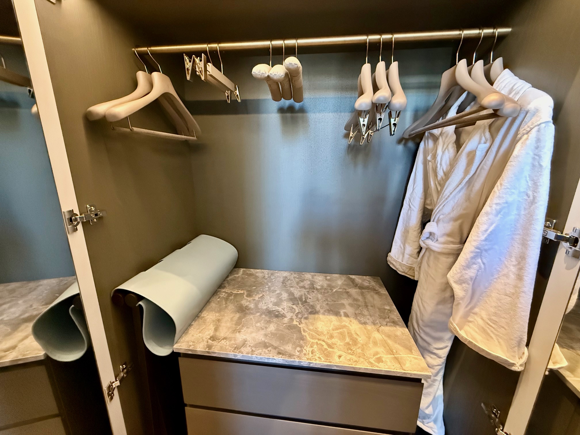 a closet with white robes and swingers