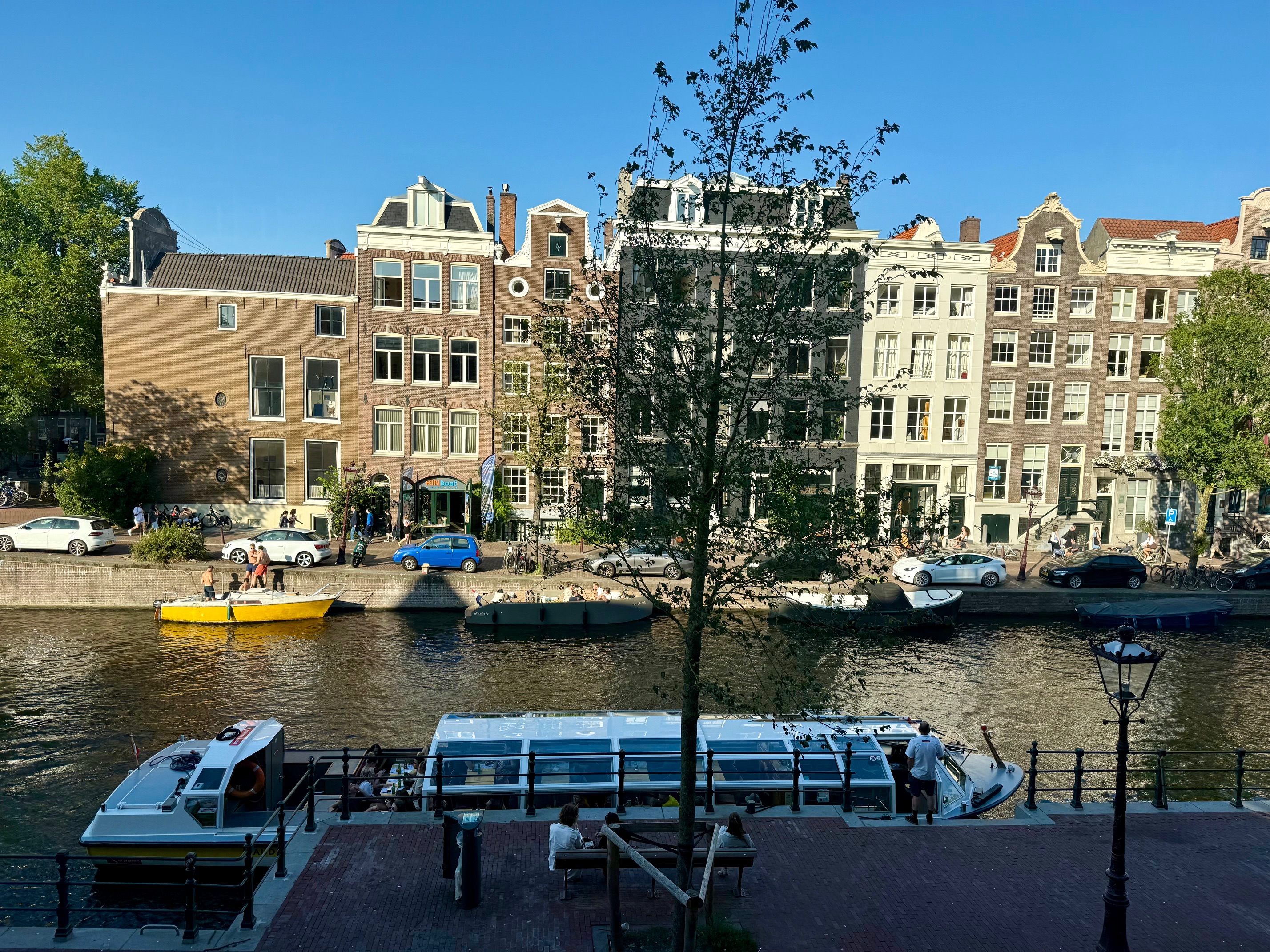a river with boats and buildings in the background