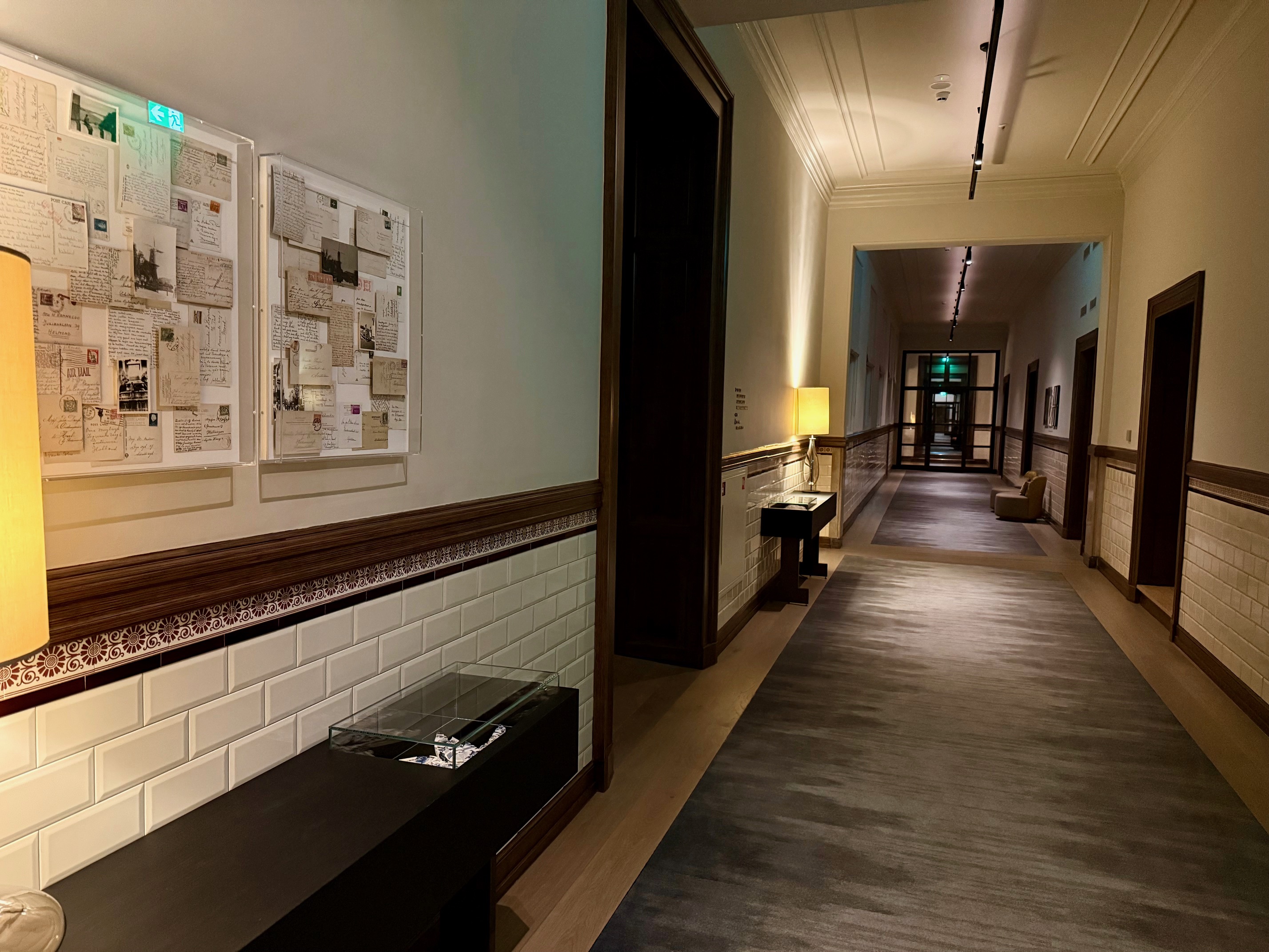 a hallway with a hallway and a hallway with a rug and a lamp