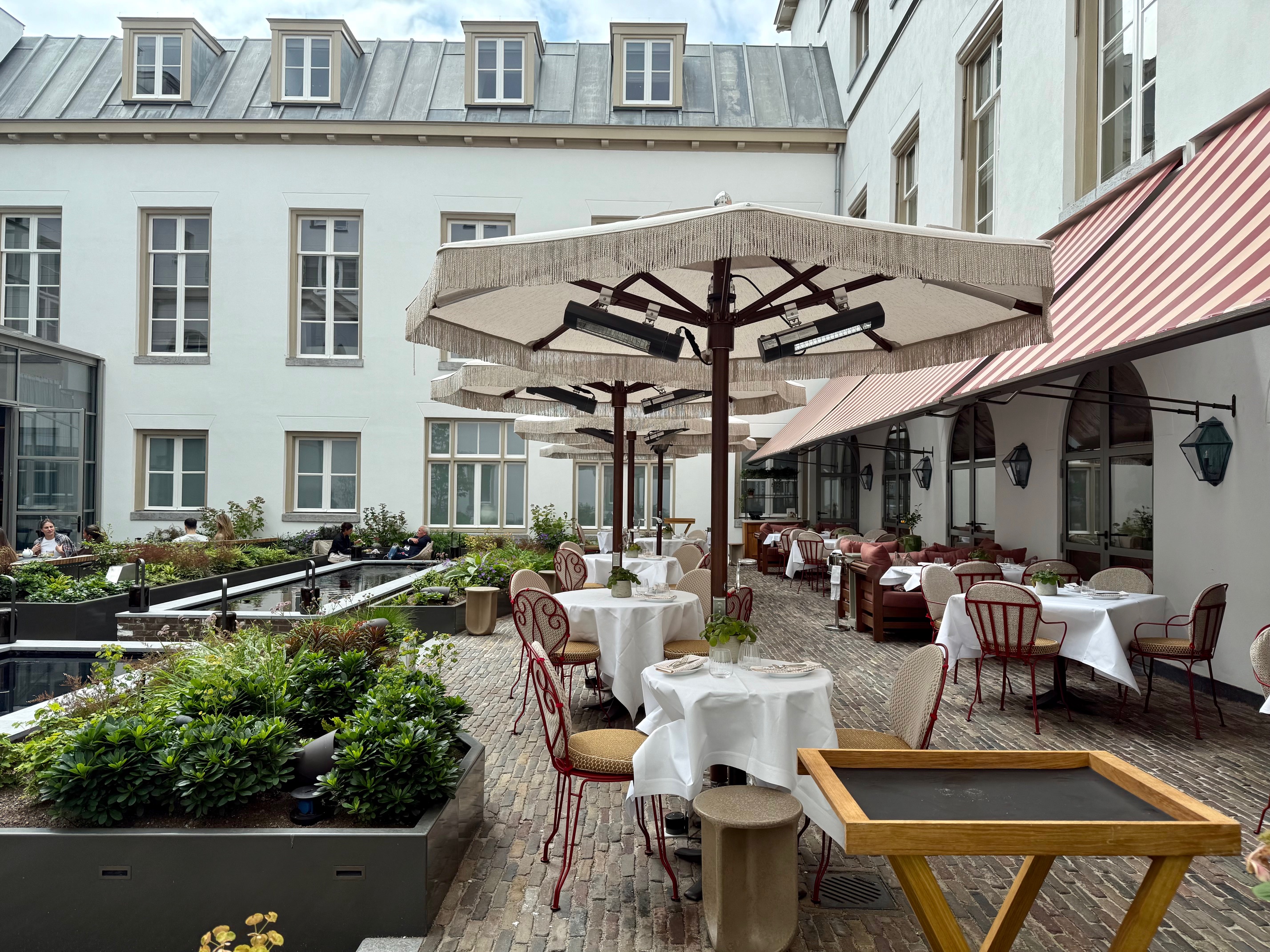 a patio with tables and umbrellas