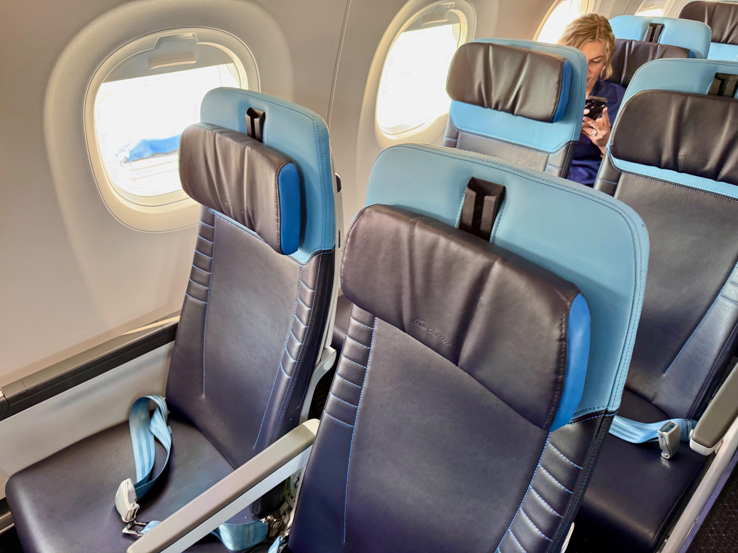 a group of seats on an airplane in KLM Business Class Embraer E195