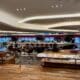 a large room with a large counter and tables at the Virgin Atlantic Clubhouse London