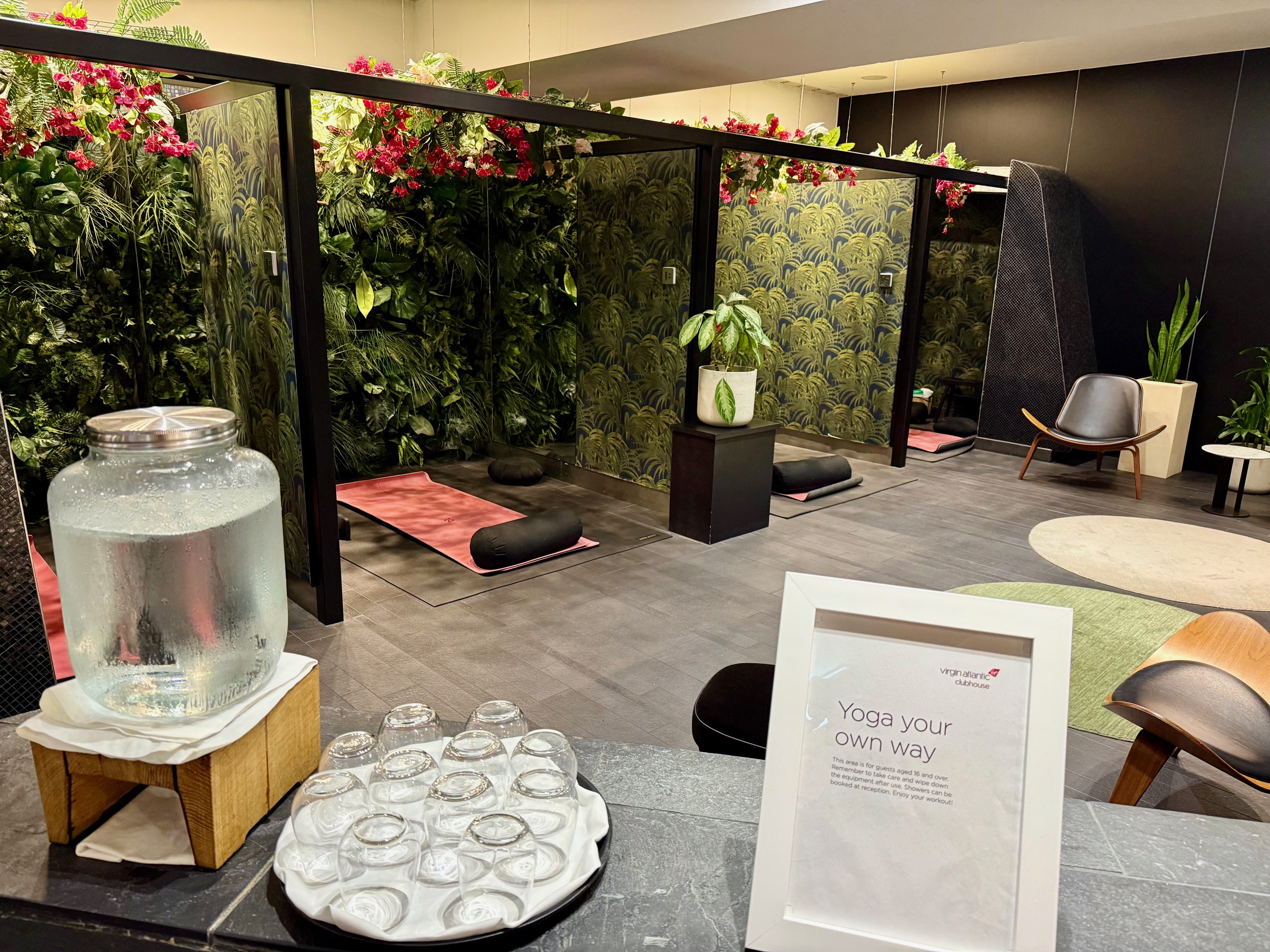 a room with a glass wall and a table with a plate of glasses
