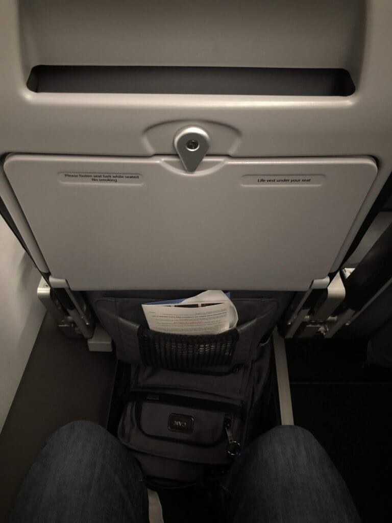 a person's legs in a pocket in a seat