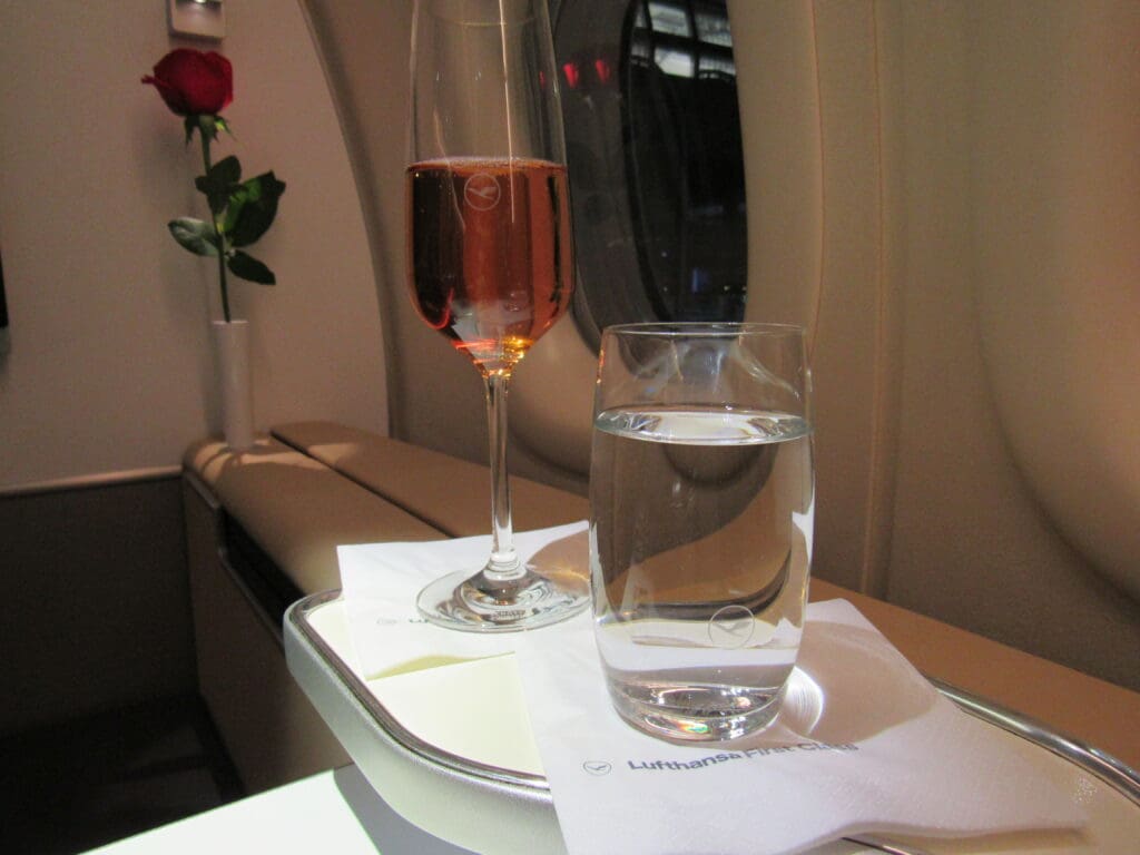 a glass of water and a wine glass on a tray