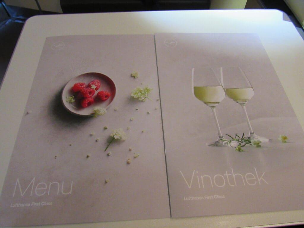 a menu with a picture of a plate and glasses of wine
